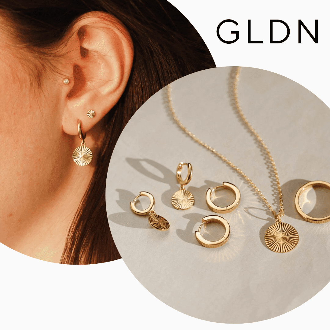 A collection of GLDN’s sustainable gold jewelry, including earrings, a necklace, and delicate handcrafted pieces made from recycled metals.